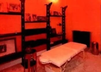 Inside Epstein's Paris lair he decorated with pictures of naked young women as red-walled massage parlour is pictured