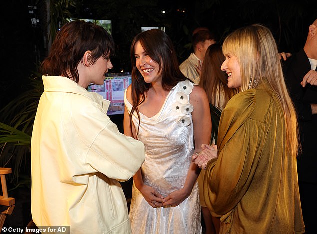 Kristen later added a white leather bomber jacket over her ensemble as she chatted away to Demi Moore and Bruce Willis' daughter Scout