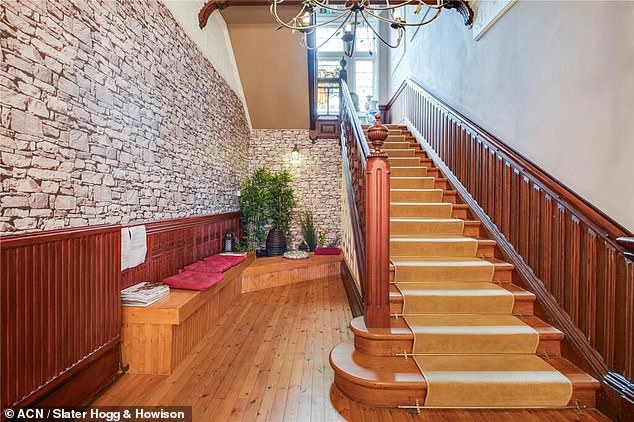 A grand staircase connects the two floors of the Baronial Villa