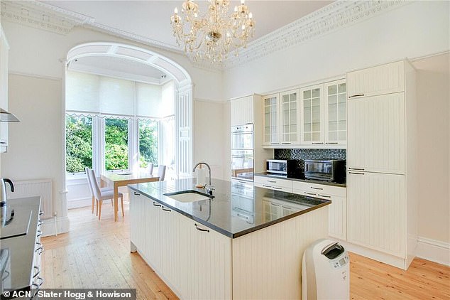 The 136-year-old castle has a modern fitted kitchen with an impressive chandelier