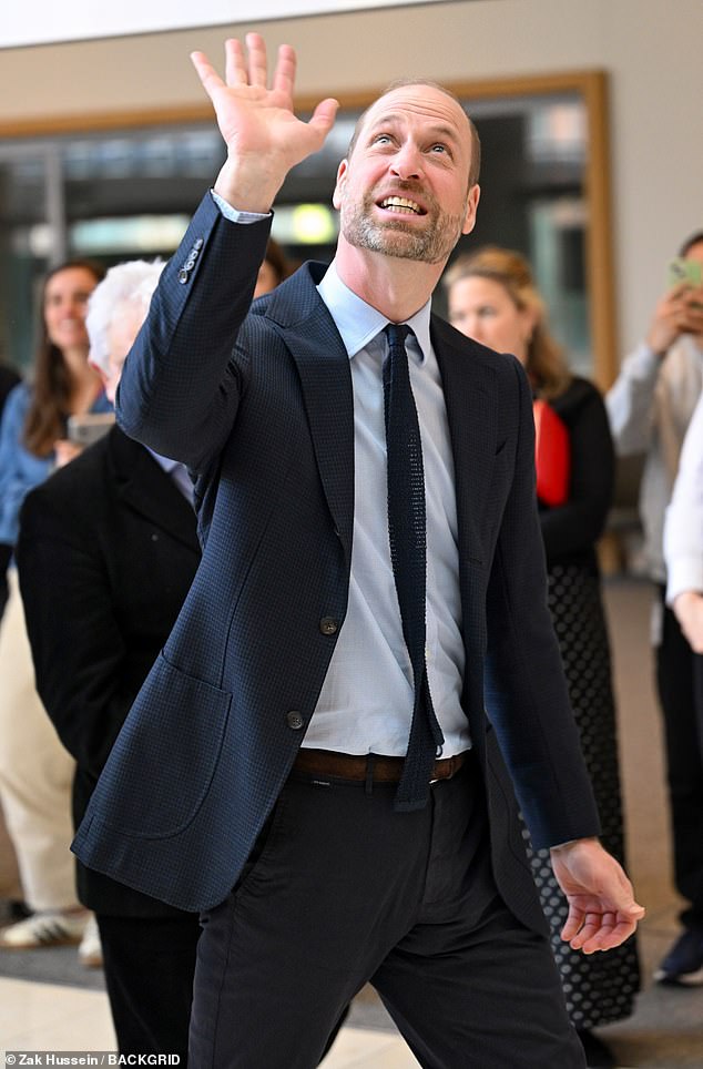 The heir to the British throne was greeted with cheers from scientists as he arrived at the research centre today
