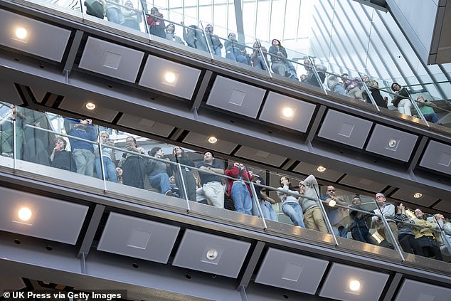 Pictured: People look on as Prince William arrived at the Francis Crick Institute in London on Wednesday