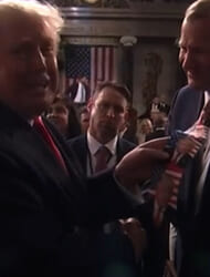 Trump joyfully signs a man’s tie after State of the Union address