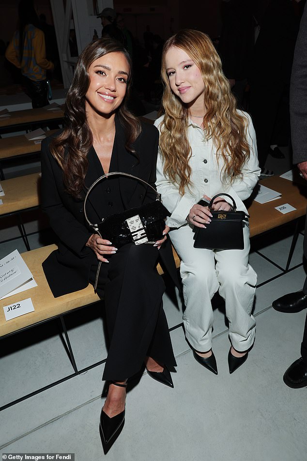 The lookalike mother and daughter both completed their flawless looks with a pair of black pointed heels as they sat in the front row
