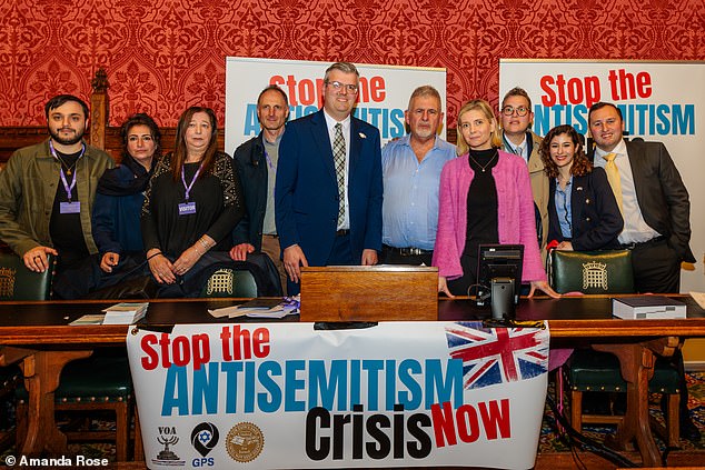 Campaigner Jeremy Wootliff (standing fifth from right), pictured with Rachel RIley and victims of antisemitism, said 'Jewish people going around their daily lives in Britain can no longer operate normally'