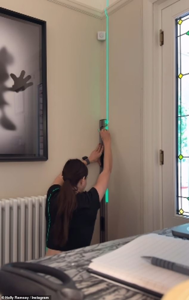 Elsewhere the influencer climbed a ladder as she used a leveller before creating wall panelling, after using a daunting saw to prepare the panels