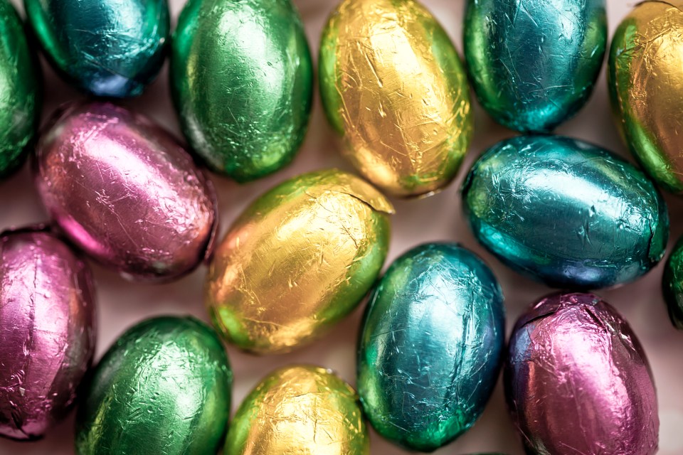 Overhead view of colorful foil-wrapped chocolate Easter eggs.