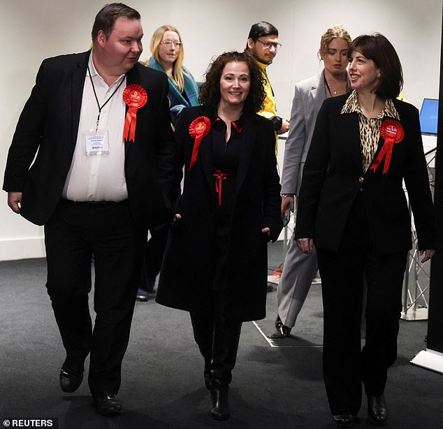 Labour's defeated candidate Ms Stogia is pictured arriving at the result declaration alongside Ms Powell and Stretford and Urmston MP Andrew Western