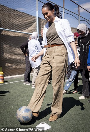 Pictured: The Duchess of Sussex dribbles with a football during a visit to the QuestScope Youth Center at the Za'atari refugee camp, home to displaced Syrians, near Mafraq in northern Jordan