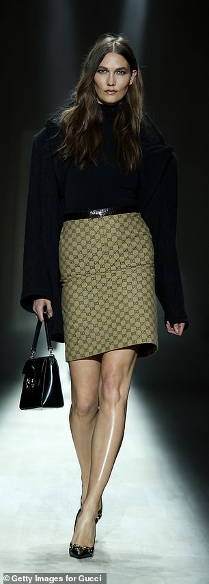 Karlie Kloss put on a leggy display in a mini skirt with the Gucci logo emblazoned,