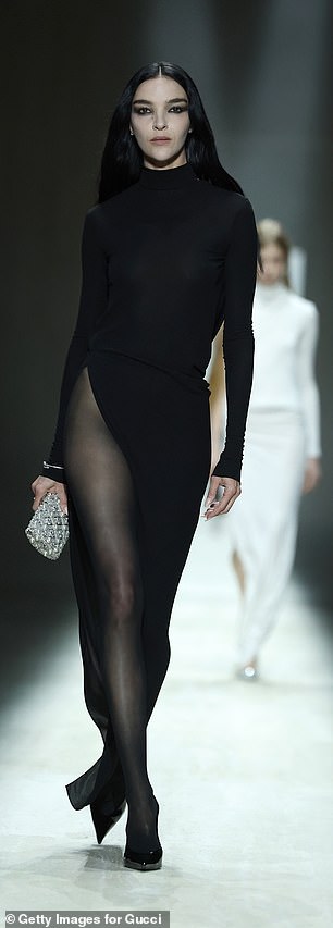 Mariacarla Boscono flashed her long legs in a black dress with a very high cut out