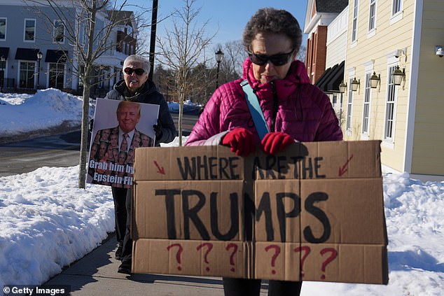 Protesters demonstrate near the Chappaqua Performing Arts Center ahead of former U.S. President Bill Clinton's closed-door deposition