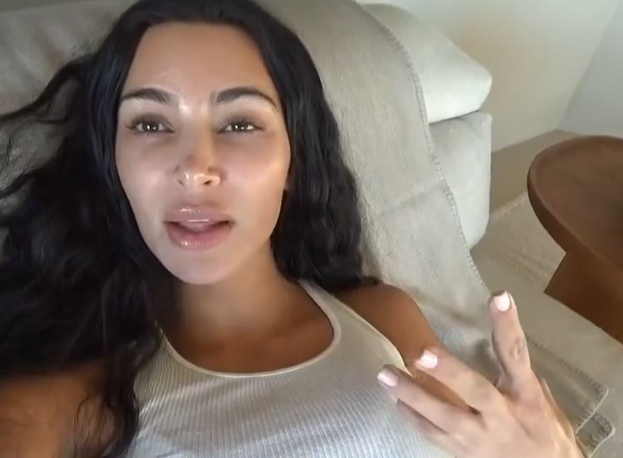 Kim Kardashian lying down, makeup-free.