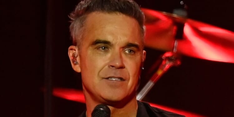 Robbie Williams ends feud with Gary Barlow as he emotionally reveals he apologised for his 'smug' behaviour