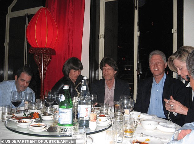 The former president was also pictured with Maxwell and singer Mick Jagger at a dinner table