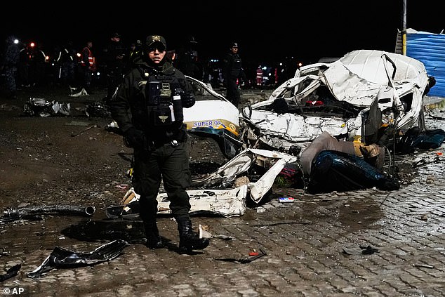 Police stand near a destroyed car that was struck by a plane in El Alto, Bolivia