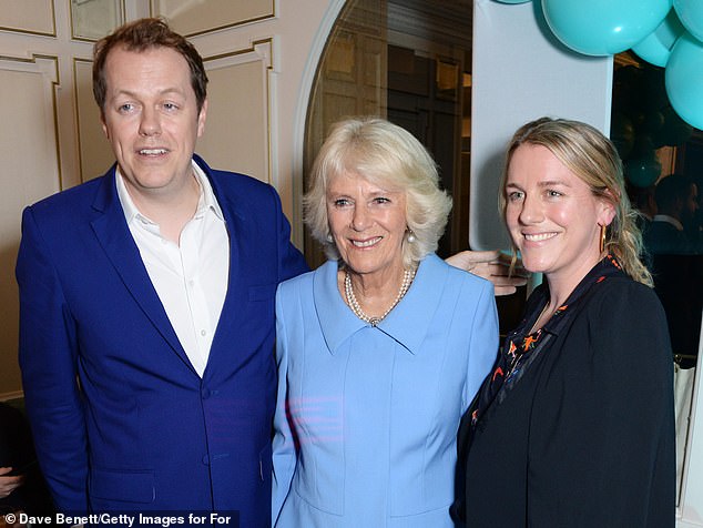 Queen Camilla (centre) pictured with her son Tom and daughter Laura