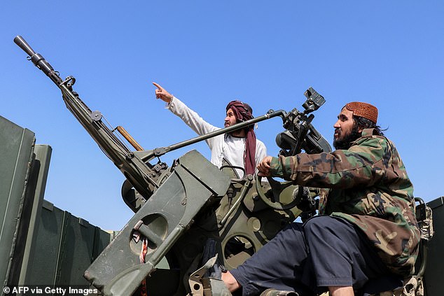 Taliban security personnel operating an anti-aircraft gun and watching for Pakistani air strikes