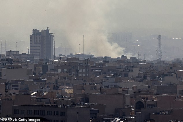 A plume of smoke rises following a reported explosion in Tehran on February 28, 2026. Two loud blasts were heard in Tehran on February 28 morning by AFP journalists, and two plumes of thick smoke were seen over the centre and east of the Iranian capital. Israel's defence ministry announced it had launched a "preemptive strike" on Iran as sirens sounded in Jerusalem and people across the country received phone alerts about an "extremely serious" threat. (Photo by ATTA KENARE / AFP via Getty Images)