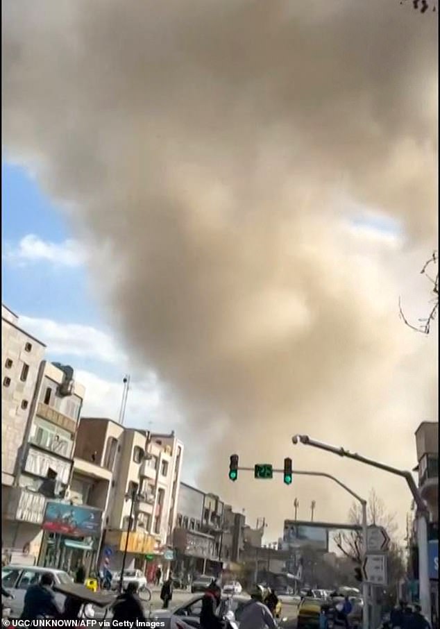 This video grab taken from UGC images posted on social media on February 28, 2026, and verified by AFPTV teams in Paris, shows traffic moving as a plume of smoke rises following a repoted explosion in Tehran. Two loud blasts were heard in Tehran on February 28 morning by AFP journalists, and two plumes of thick smoke were seen over the centre and east of the Iranian capital. Israel's defence ministry announced it had launched a "preemptive strike" on Iran as sirens sounded in Jerusalem and people across the country received phone alerts about an "extremely serious" threat. (Photo by various sources / AFP via Getty Images) / - Israel OUT / RESTRICTED TO EDITORIAL USE - MANDATORY CREDIT AFP -  SOURCE: UGC / UNKNOWN - DISTRIBUTED AS A SERVICE TO CLIENTS - NO RESALE - NO ACCESS ISRAEL MEDIA/PERSIAN LANGUAGE TV STATIONS OUTSIDE IRAN/ STRICTLY NO ACCESS BBC PERSIAN/ VOA PERSIAN/ MANOTO-1 TV/ IRAN INTERNATIONAL/RADIO FARDA - AFP IS NOT RESPONSIBLE FOR ANY DIGITAL ALTERATIONS TO THE PICTURE'S