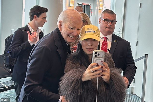 Former President Joe Biden takes a selfie with a passenger Friday morning as he awaited his flight to Columbia, South Carolina at the Ronald Reagan Washington National Airport. Biden is lobbying to keep South Carolina the first state to hold a Democratic primary in 2028