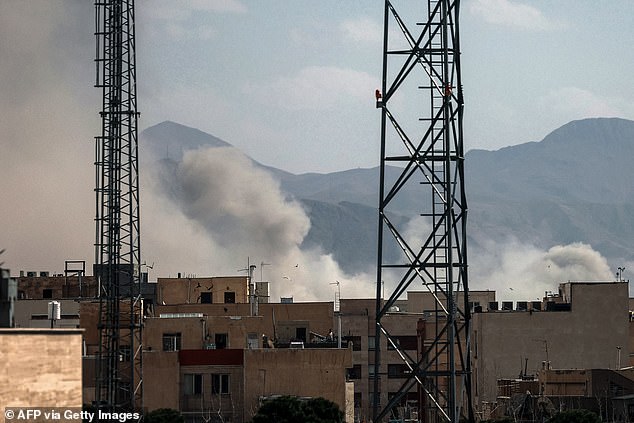 A plume of smoke rises above Tehran after the joint U.S. and Israeli strikes ob Saturday