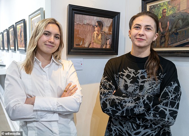 Viktorria and her sister Maryna, 30, at the Osborne Studio gallery looking at their portraits from the front line