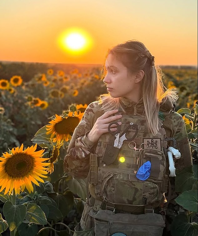 A portrait of Viktoriia sitting in a ruined tank in the city of Bakhmut in 2023 hangs in the reception of the UK Defence Academy in Shrivenham
