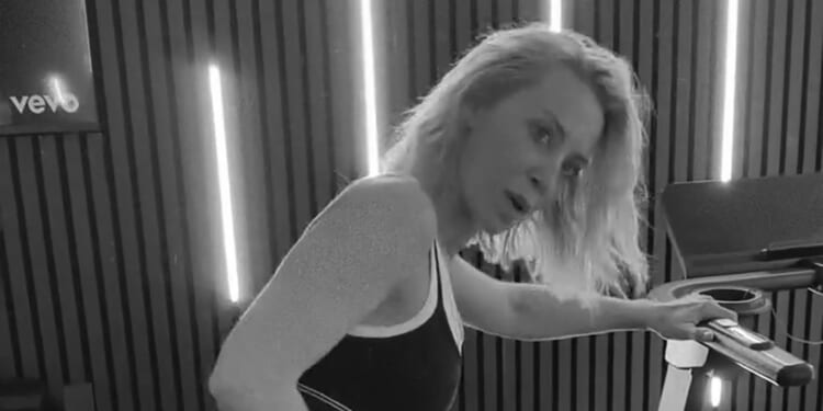 A Place In The Sun's Laura Hamilton works up a sweat in tiny bra and leggings as she shows off flexibility