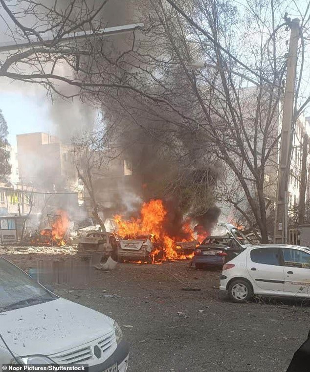 A vehicle explodes into flames after the US carried out strikes on Iran