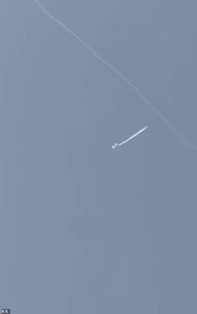 In the video, with over half a million views, the woman says, 'Oh my god' as she pans the camera across the pool and back up to two plumes of smoke in the sky