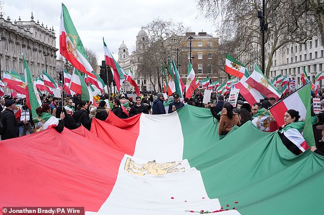 The rally (pictured) was organised by the Stage of Freedom group, which opposes the Ayatollahs' regime and supports the American strikes