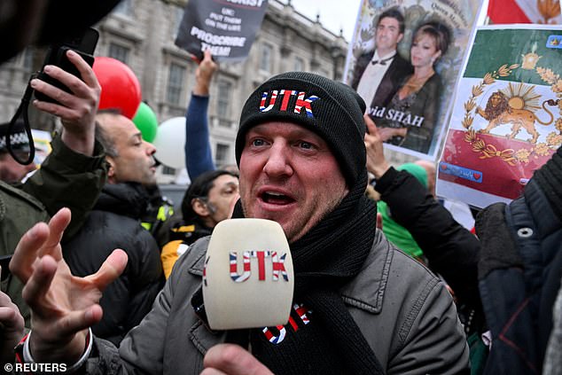 Demonstrators, who were joined by far-right activist Stephen Yaxley-Lennon (pictured, at the rally), also known as Tommy Robinson, gathered outside the Ministry of Defence in central London (pictured) ahead of a march down to the Iranian embassy