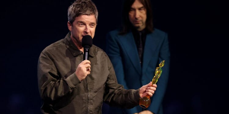 Noel Gallagher is BOOED at the Brits just seconds after picking up prestigious award