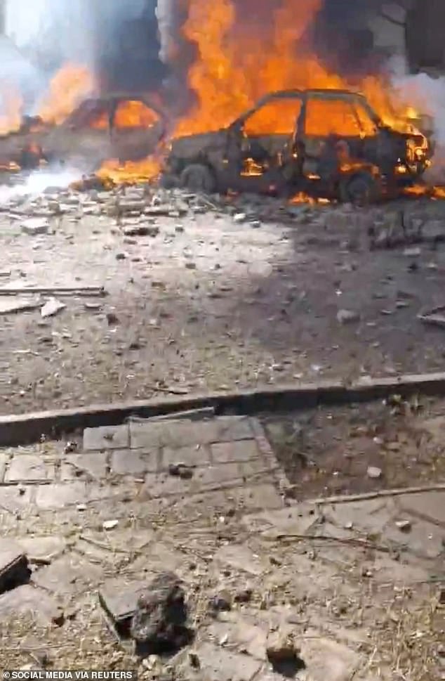 Vehicles burning in Tehran on Saturday after air strikes by Israel and the US