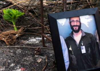 A photograph of 37-year-old Alex Pretti can be seen at a makeshift memorial in the area where he was shot dead by federal immigration agents earlier in the day in Minneapolis, Minnesota, on Jan. 24, 2026.