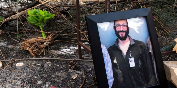 A photograph of 37-year-old Alex Pretti can be seen at a makeshift memorial in the area where he was shot dead by federal immigration agents earlier in the day in Minneapolis, Minnesota, on Jan. 24, 2026.