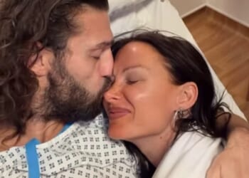 Andy Carroll revealed he had undergone surgery on a fracture and ligaments as he shared a clip from his hospital bed on Saturday (pictured with girlfriend Lou Teasdale)