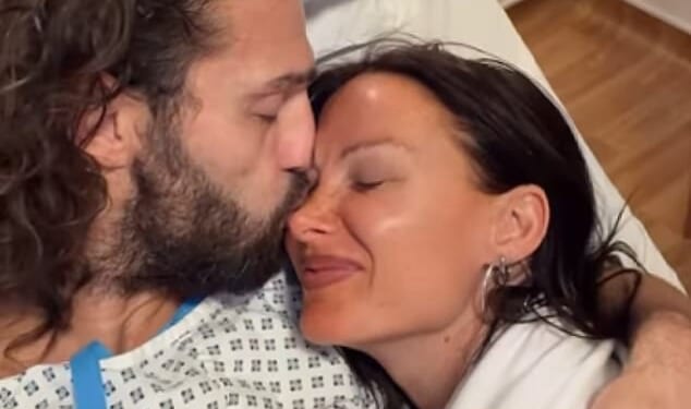 Andy Carroll revealed he had undergone surgery on a fracture and ligaments as he shared a clip from his hospital bed on Saturday (pictured with girlfriend Lou Teasdale)