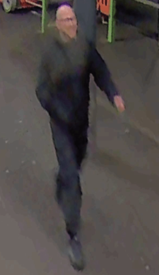 Security camera footage of a man in glasses and dark clothing.
