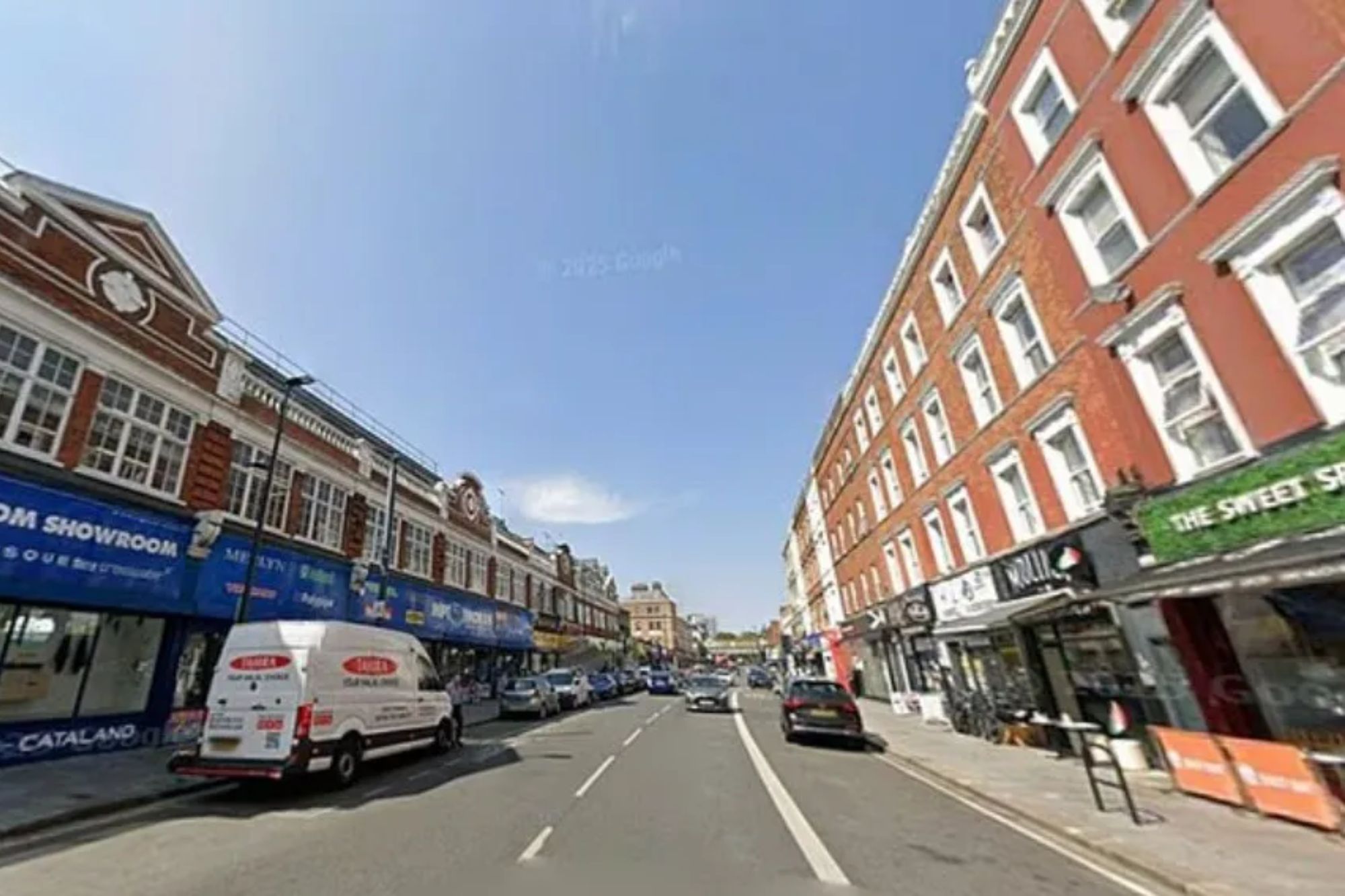An image collage containing 1 images, Image 1 shows Street lined with shops and apartments, with a white van parked in front of a "Bathroom Showroom" and cars driving on the road