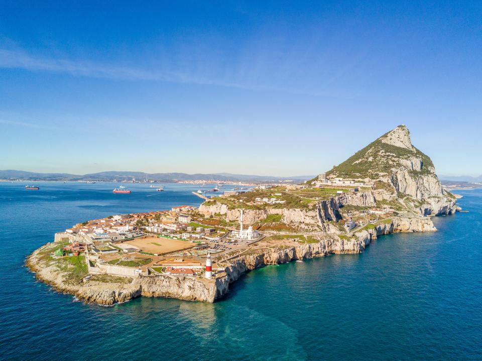 Aerial view of the Rock of Gibraltar and the surrounding city, coastline, and sea.