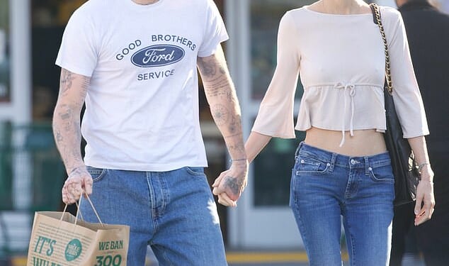 Brooklyn Beckham displayed his covered up tattoo tribute to his father Sir David during an outing in Los Angeles with his wife Nicola Peltz on Wednesday