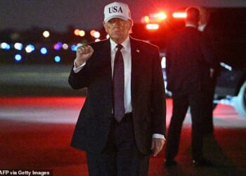 US President Donald Trump makes a fist after he steps off Air Force One upon arrival at Palm Beach