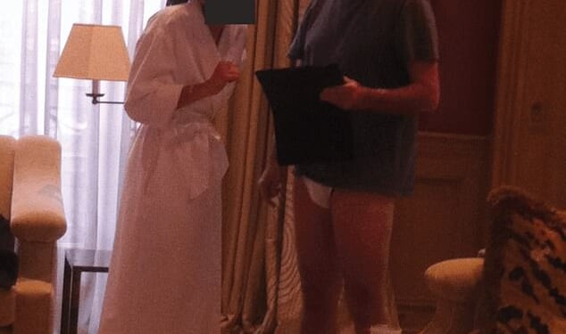 A photograph released as part of the Epstein files apparently shows Lord Mandelson talking to a woman who is wearing a white bath robe