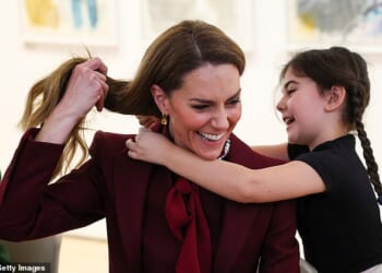 Catherine, Princess of Wales, receives a necklace made by a child at an art workshop during a visit to a project funded by the Alexandra Reinhardt Memorial Award, focused on supporting the well-being of the children and young people in the local area at Oriel Davies, a public contemporary art gallery, on February 26, 2026 in Newtown, Wales