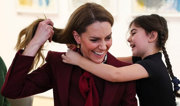 Catherine, Princess of Wales, receives a necklace made by a child at an art workshop during a visit to a project funded by the Alexandra Reinhardt Memorial Award, focused on supporting the well-being of the children and young people in the local area at Oriel Davies, a public contemporary art gallery, on February 26, 2026 in Newtown, Wales
