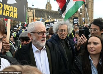 Jeremy Corbyn (centre left) was seen with his brother Piers (centre right) alongside supporters of the regime at a rally in Parliament Square on Saturday