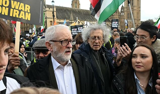 Jeremy Corbyn (centre left) was seen with his brother Piers (centre right) alongside supporters of the regime at a rally in Parliament Square on Saturday