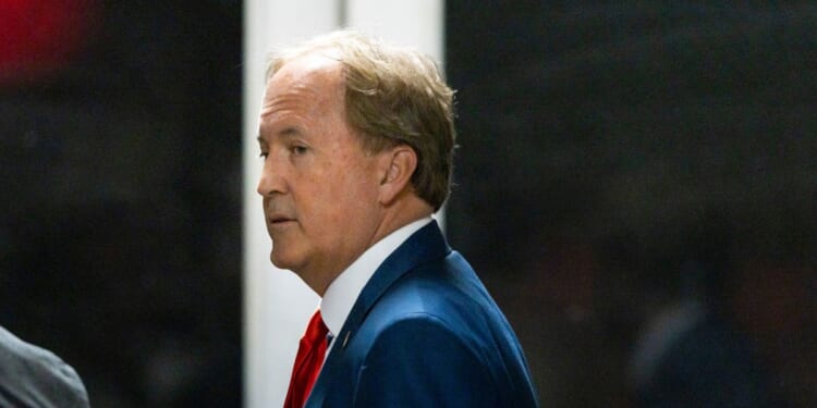 Texas Attorney General Ken Paxton arrives with President Donald Trump to court during Trump's trial for allegedly covering up hush money payments at Manhattan Criminal Court on April 30, 2024, in New York City.
